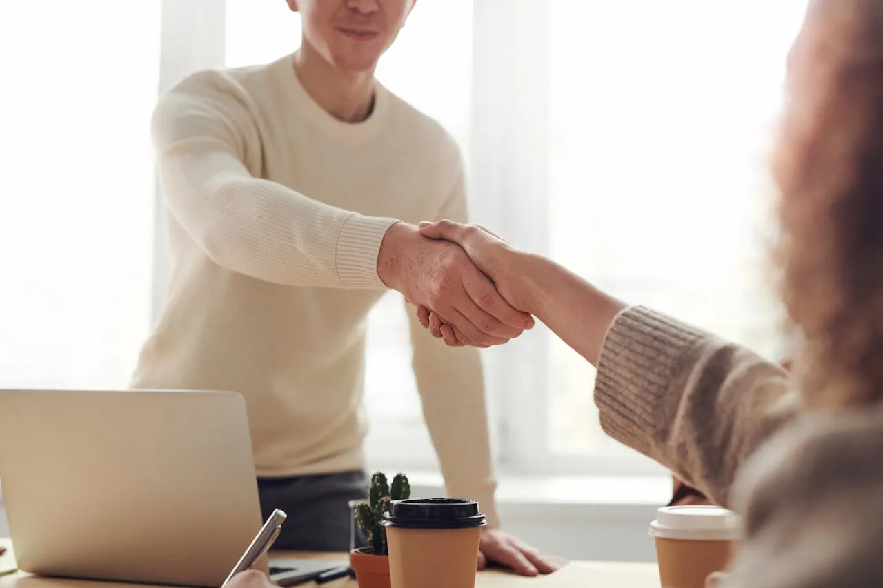 Men in business shaking hands over a table